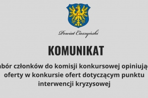 Na szarym tle umieszczony herb z żółtym orłem na niebieskim tle, poniżej czarny napis ozdobnym fontem „Powiat Cieszyński”. Centralnie widoczny duży, pogrubiony napis „KOMUNIKAT”, a niżej informacja o naborze członków do komisji konkursowej dotyczącej punktu interwencji kryzysowej.